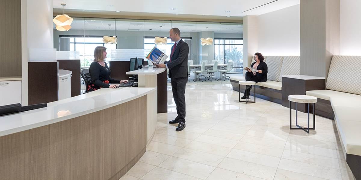 Open office space with a curved reception desk.